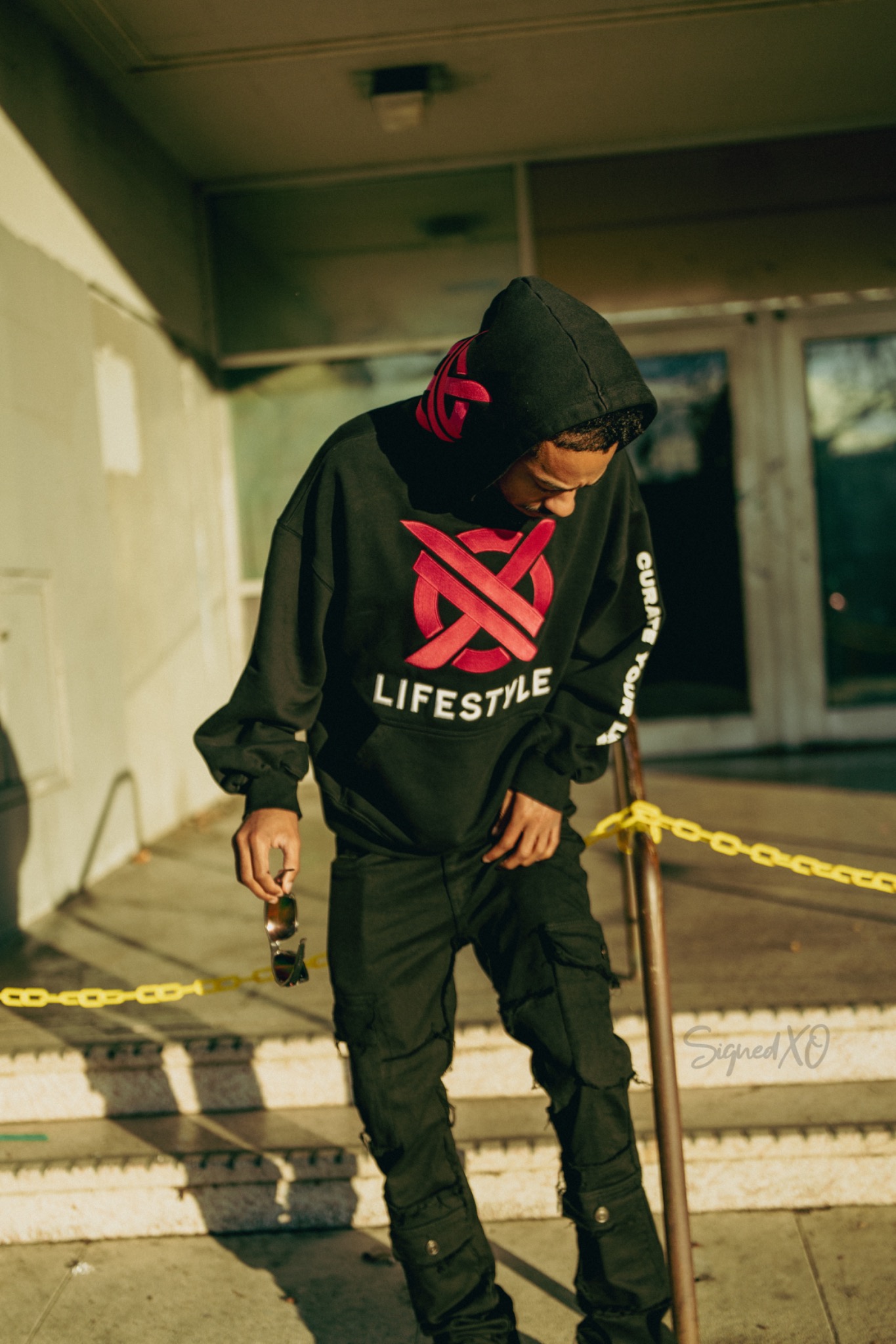 Front of XO Lifestyle black and magenta hoodie